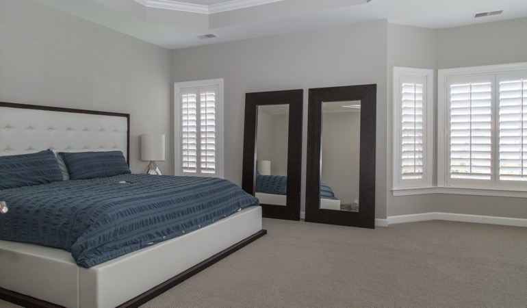 Polywood shutters in a minimalist bedroom in Southern California.